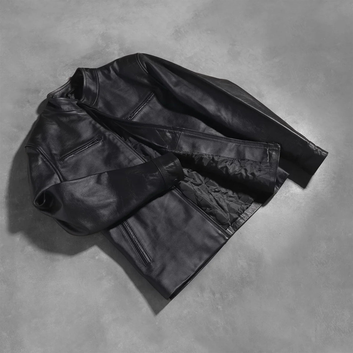 Styled Fit Perspective of Austere Matte Black Leather Biker Jacket on Model - Natural Daylight Drape