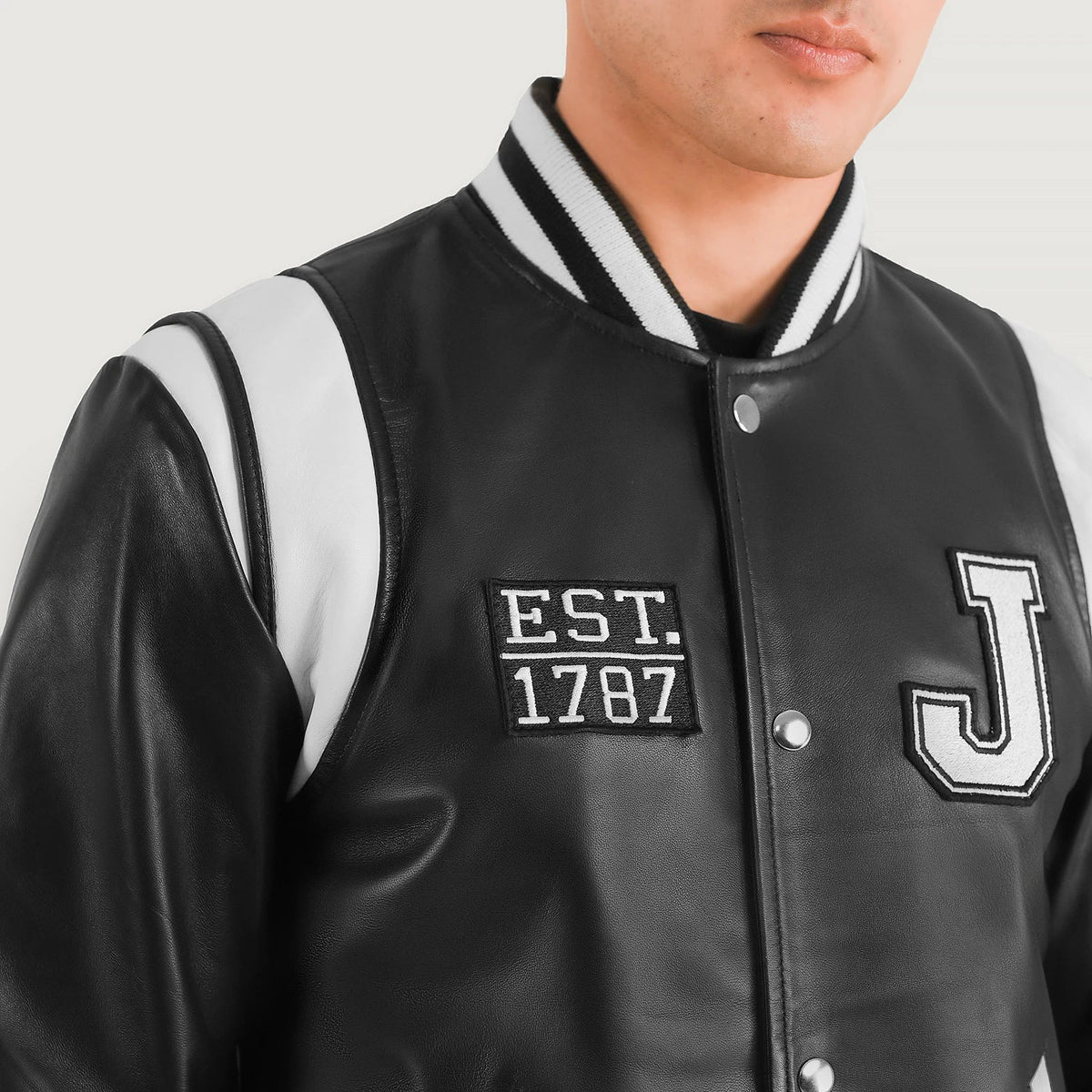 Close-Up Detail of Varsity & Snap Button Hardware on Liberte New Jersey Black Leather Varsity Jacket