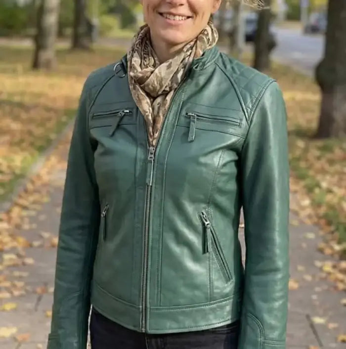 Verified client Marcus Vance (Brooklyn, NY, US) wearing the Orlaven Women Green Diamond Cafe Racer Real Leather Jacket in deep emerald green supple full-grain lambskin leather, layered effortlessly over an ivory cashmere knit for cold days in Brooklyn, NY.