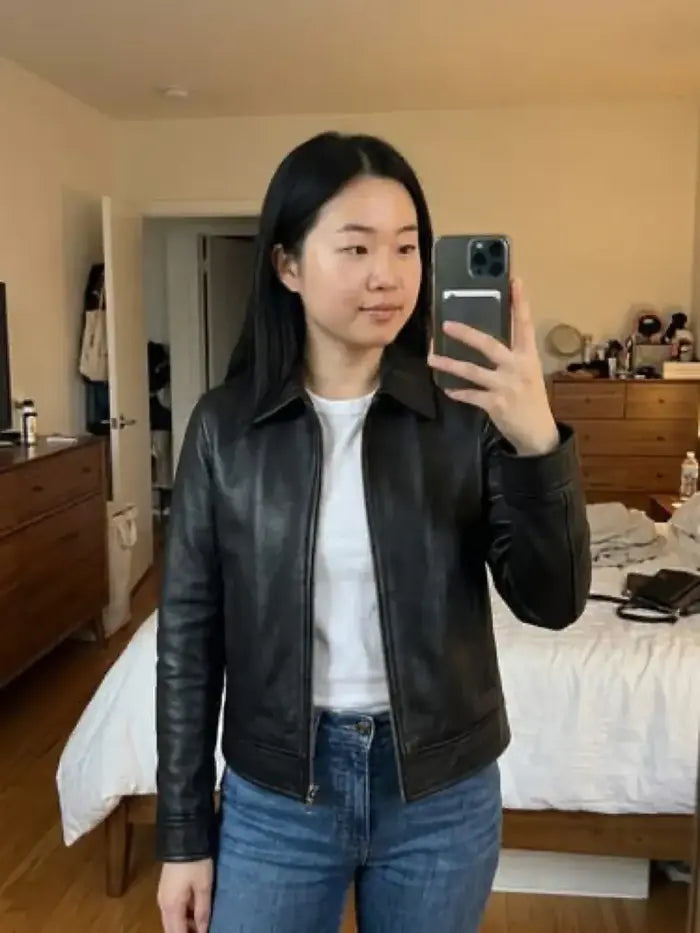 Verified client Chloe Bennett (Toronto, CA) wearing the Orlaven Women’s Classic Black Harrington Leather Jacket in deep onyx black supple full-grain lambskin leather, layered effortlessly over an ivory cashmere knit for cold days in Toronto.