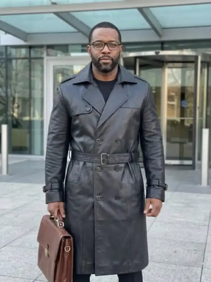 Verified client Sophie Laurent (Montreal, CA) wearing the Orlaven Mens Belted Double Breasted Black Leather Trench Coat in deep onyx black tailored full-grain calfskin leather, displaying authentic leather patina and rugged asymmetrical moto styling.