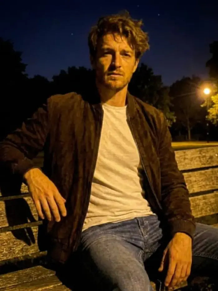 Verified client James Gerrity (Manchester, UK) wearing the Orlaven Men’s Dark Brown Suede Bomber Jacket in dark chocolate brown full-grain calfskin suede, featuring clean tailored shoulder drape and heavy brass hardware.